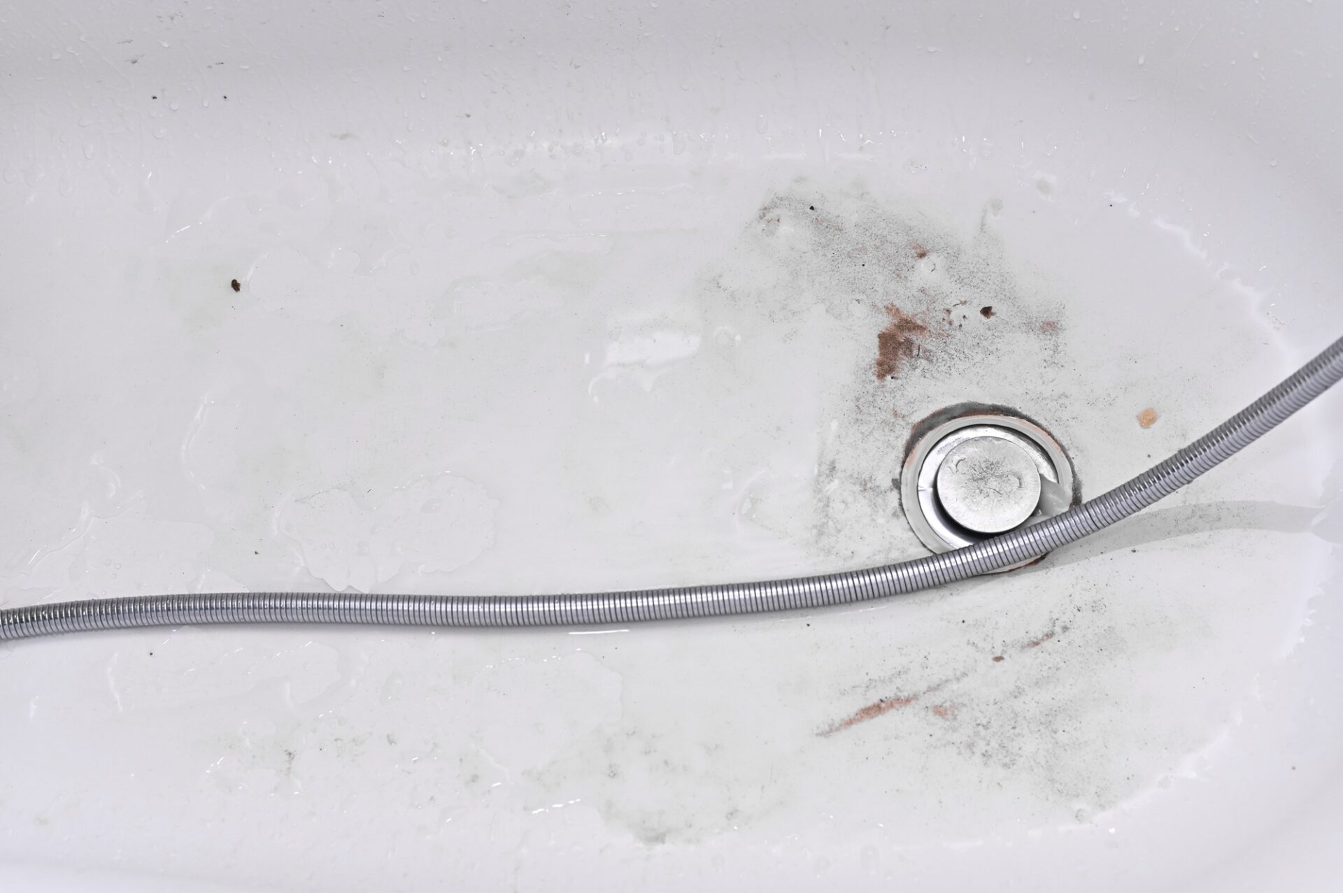 dirty tub, dirt accumulated together on left.